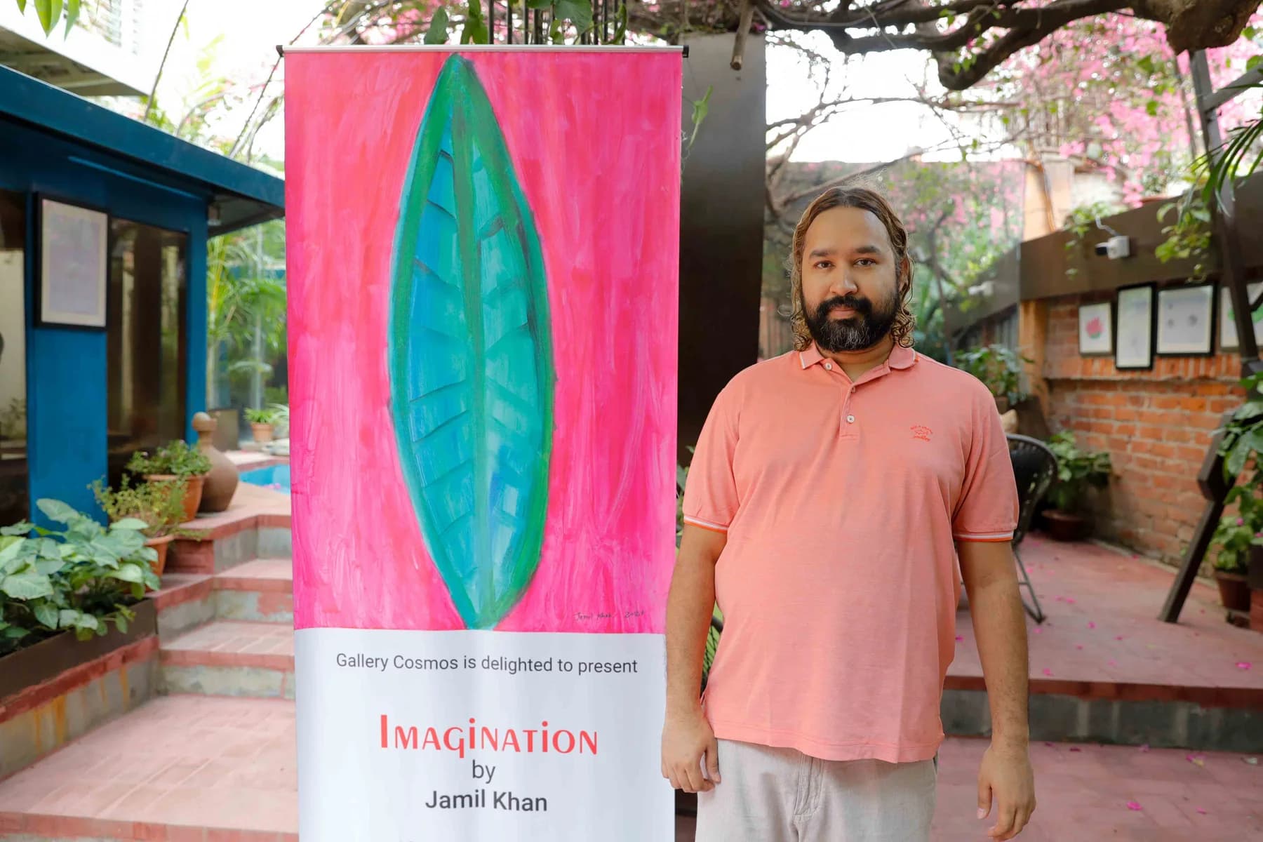 The artist beside the Imagination banner — Imagination, a presentation of work by Jamil Khan at Gallery Cosmos