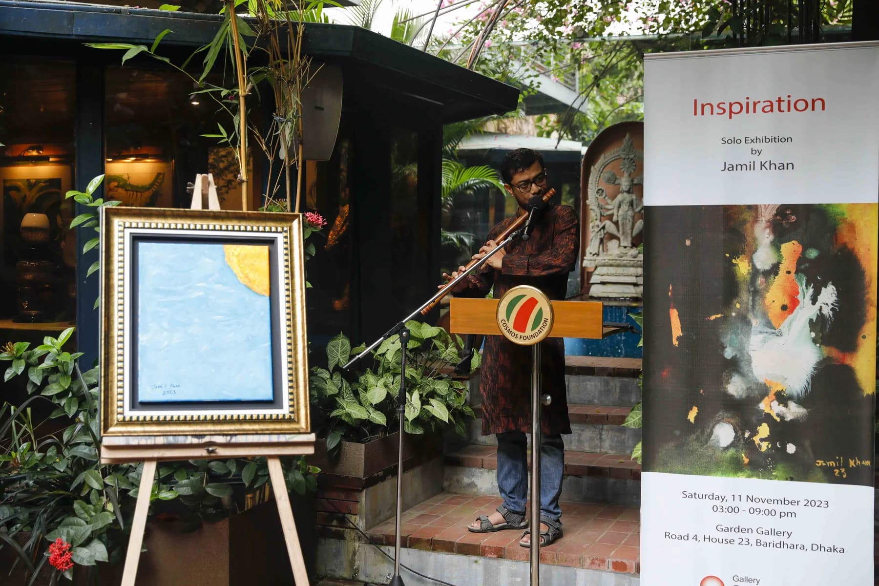 The exhibition banner in the garden — Inspiration, a solo exhibition by Jamil Khan at Gallery Cosmos
