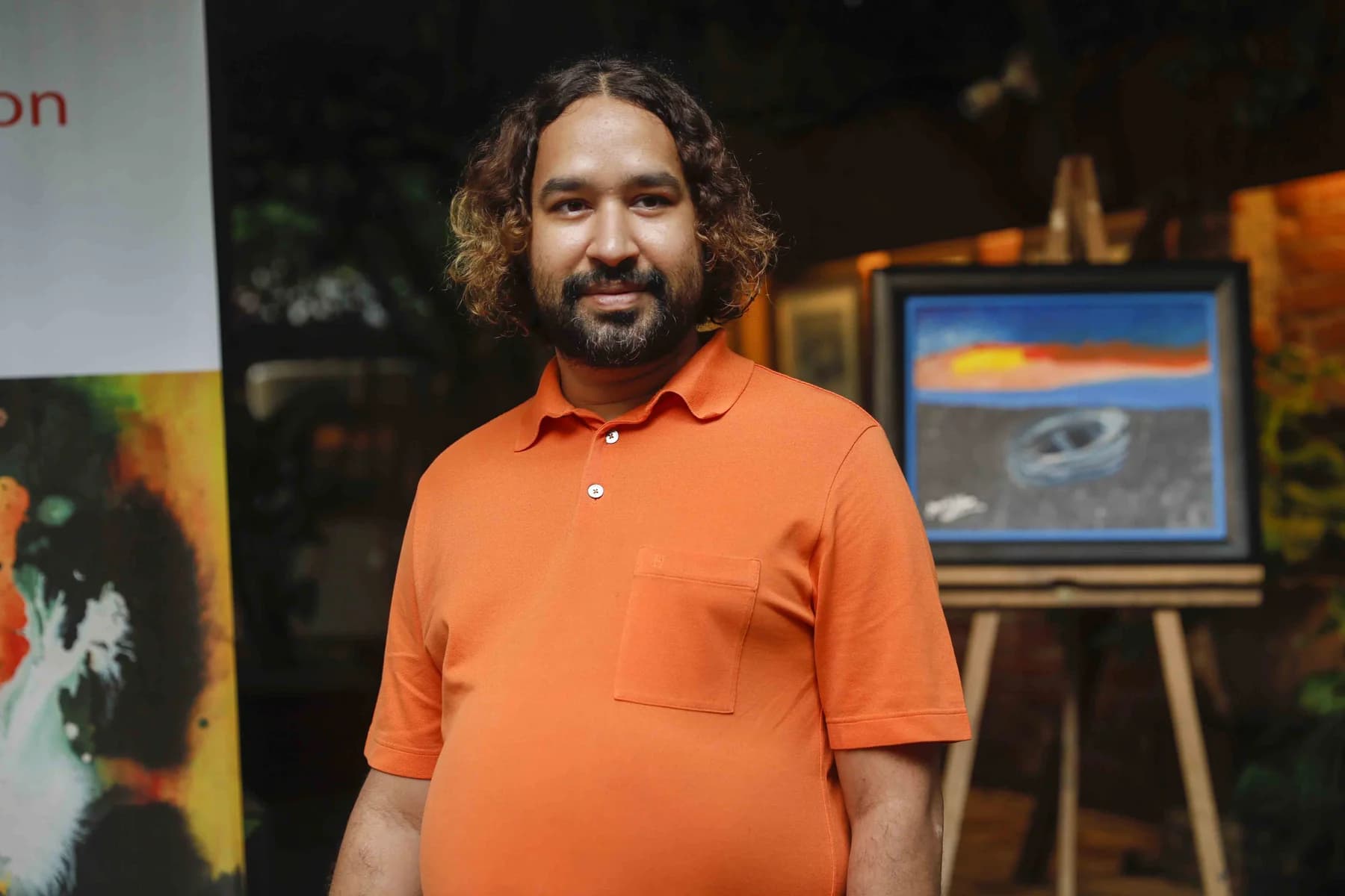 The artist beside his work — Inspiration, a solo exhibition by Jamil Khan at Gallery Cosmos