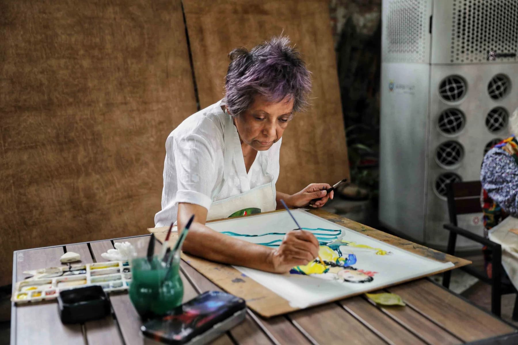 Painting at an outdoor table — the Live Drawing and Exhibition day at Gallery Cosmos