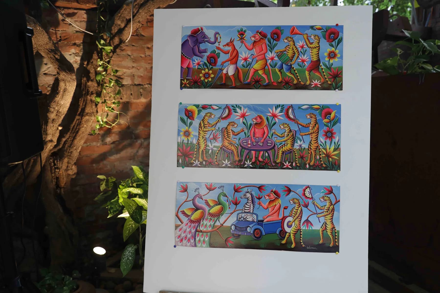 Rickshaw-painted panel on an easel — Rickshaw Art Exhibition at Gallery Cosmos