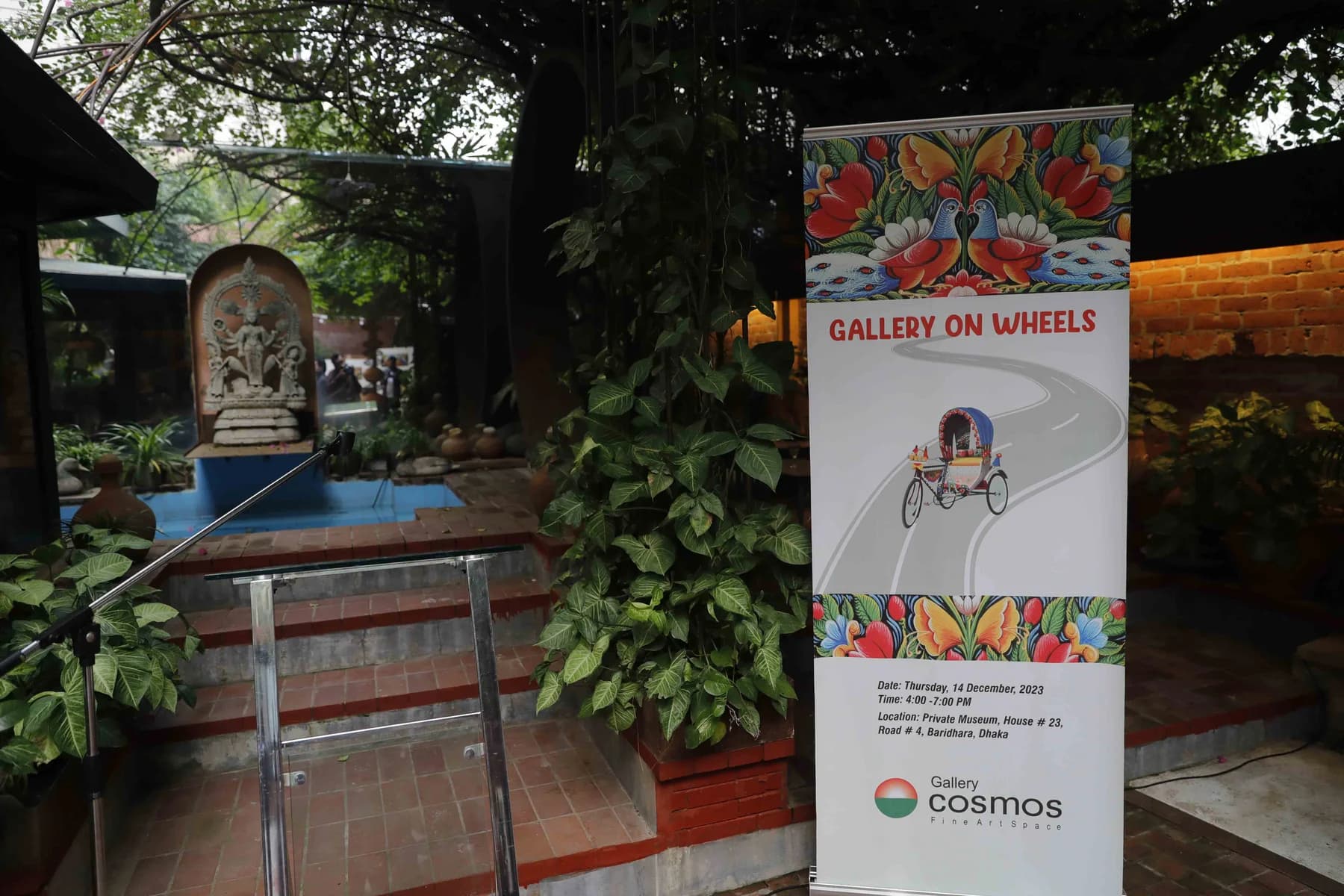 Gallery on Wheels banner at the garden entrance — Rickshaw Art Exhibition at Gallery Cosmos